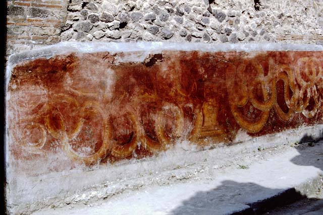 VII.11.13  Pompeii. December 2005. Detail of painted street altar on outside wall.   