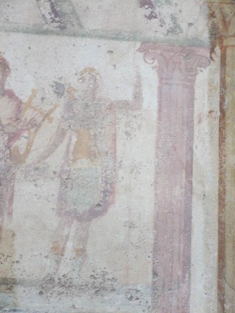 Detail of Diana outside IX.11.1. December 2006. Diana: Wreath or crown in the hair, short green violet tunic, yellow coat hanging on left side, quiver and bow behind right shoulder, Patera or libation dish in the right hand and venabulum or spear in the left. See Lararien und Fassadenbilder in den Vesuvstadten by Thomas Frohlich, F66, page 335-337.