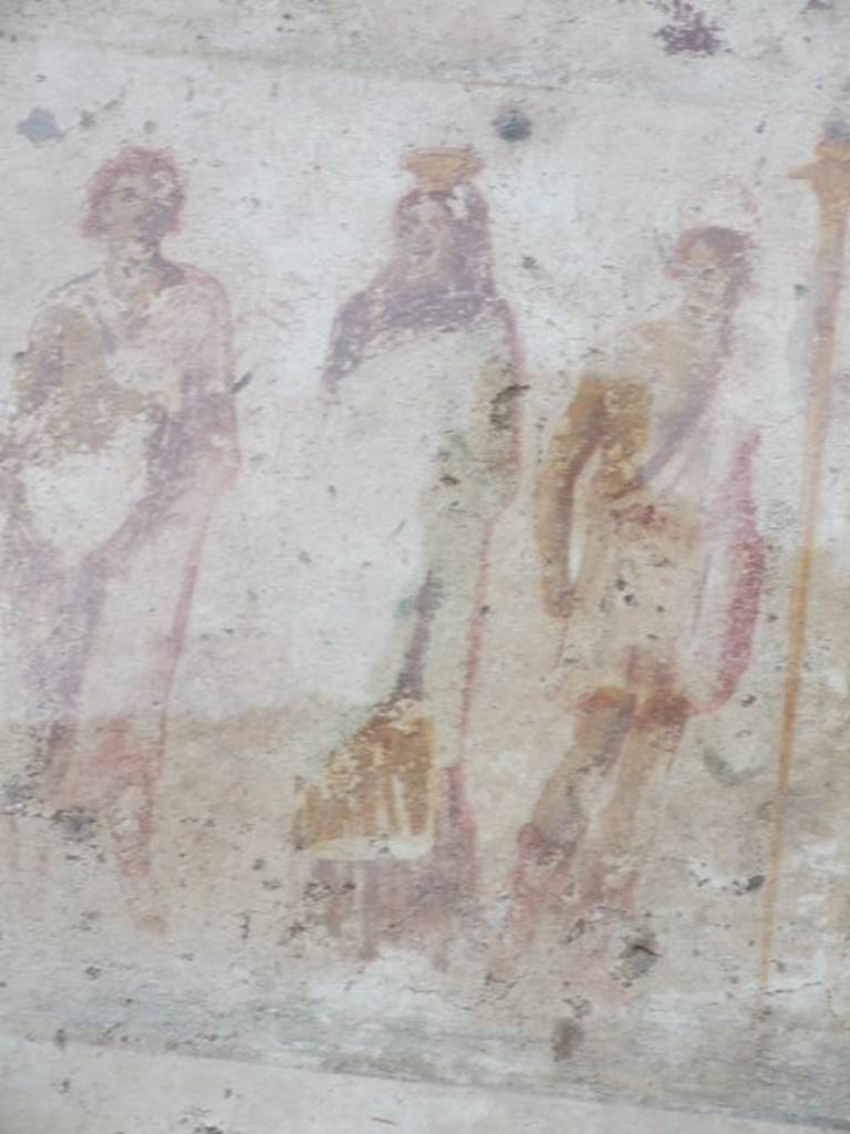 Detail of Proserpina outside IX.11.1. December 2006. Proserpina?: Wrapped completely in red, right arm under the coat, carrying a green Chiton, a golden modius or harvest basket is on her head. See Lararien und Fassadenbilder in den Vesuvstadten by Thomas Frohlich, F66, page 335-337.