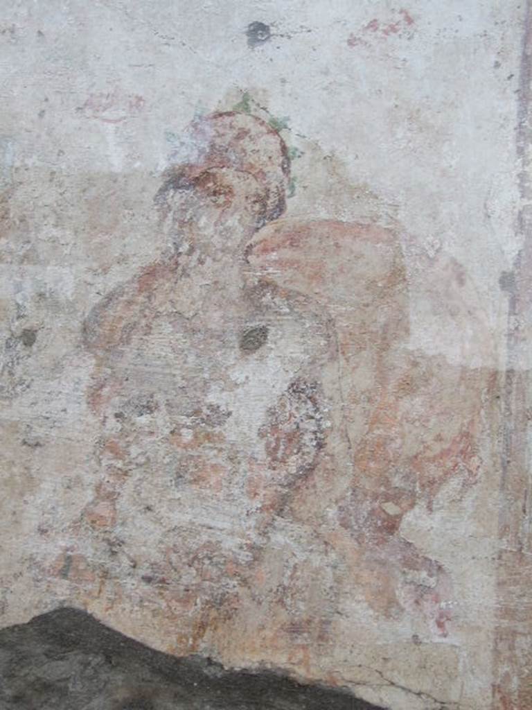 Detail of painted figure, perhaps one of the two Lares, outside IX.11.1. December 2006.
