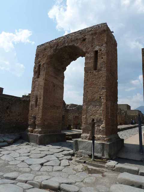 Arch of Caligula. May 2010. Looking north from arch at the start of the Via Mercurio. A bronze equestrian statue was found in pieces beneath the arch. This was (arbitrarily) identified as being Caligula and may have come from the top of the arch. Now in Naples Archaeological Museum.  Inventory number 5635. According to Welch, the statue wears a toga and senatorial sandals and is realistically portrayed as middle aged. She suggests it is more likely to be a high ranking civic person. She suggests that it may be Marcus Tullius who was tribunus militum a populus a non military but equestrian rank. He was also the donor of the adjacent Temple of Fortuna Augustus in the Augustan period. See Welch K. E. in Dobbins, J. J. and Foss, P. W., 2008. The World of Pompeii. Oxford: Routledge. (p.551-554, fig. 36.2a-c).