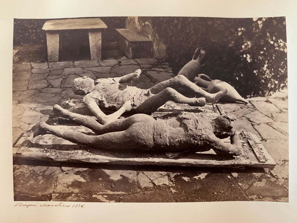 Victims numbered 9 and 10, on display. From an Album by M. Amodio, c.1880, entitled “Pompei, destroyed on 23 November 79, discovered in 1748”.
These fugitives were found in the middle of the Via del Vesuvio (Via Stabiana) at about a height of four metres from the ancient street level, near the north-eastern corner of Reg. VI.14. Photo courtesy of Rick Bauer.