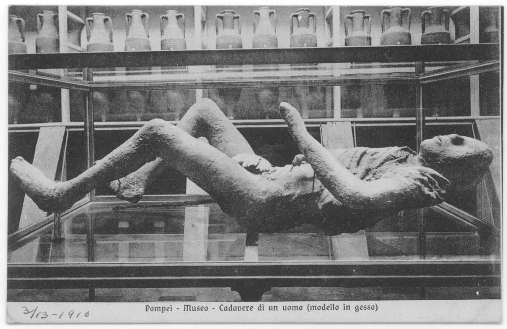Victim 9, with fig leaf applied to the cast’s body, photographed in display case in museum, c.1900.
Part of the metal stick found with the victim is exhibited on the right side of the cast. Photo courtesy of Eugene Dwyer.