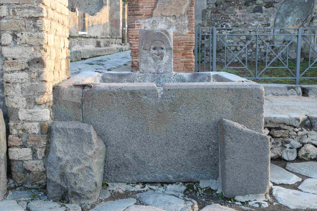 Fountain outside I.4.15 on Via Stabiana. December 2018. 
Looking across Holconius� crossroads towards fountain. Photo courtesy of Aude Durand.
