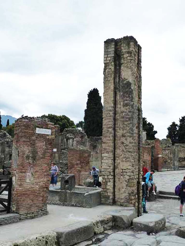 Fountain outside I.4.15 on Via Stabiana. May 2010. 
North and east sides of fountain and water column on the south side of the Via dell�Abbondanza, at the junction with Via Stabiana. 


