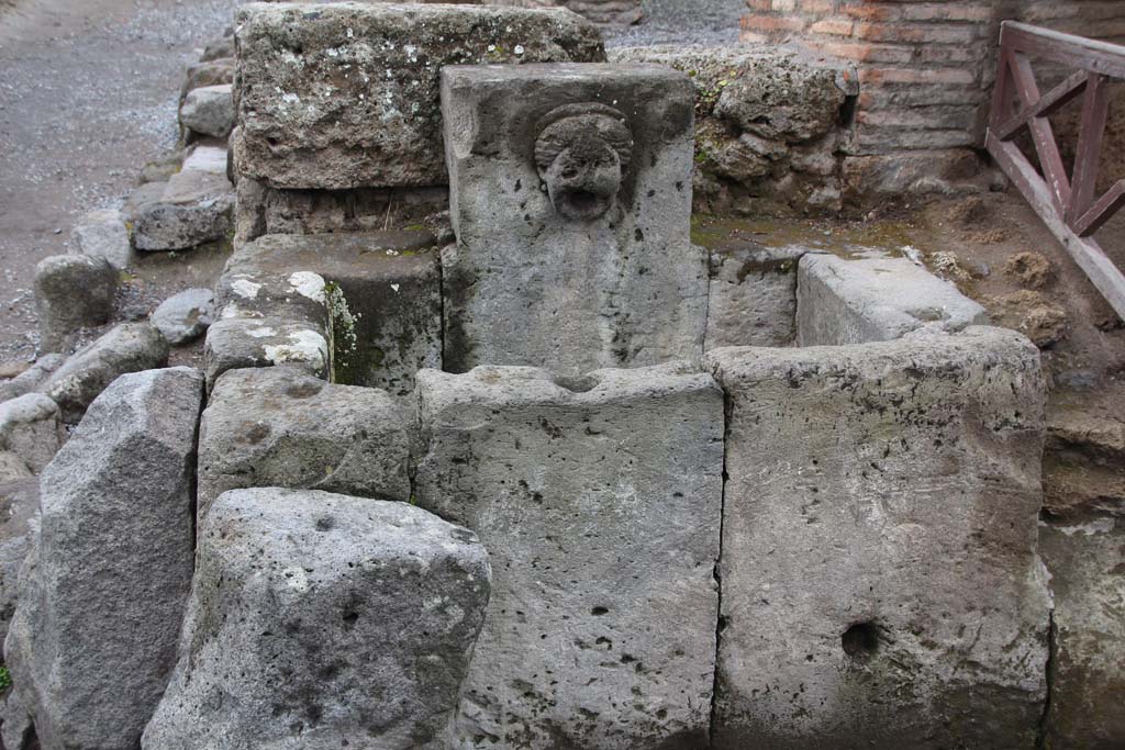 I.13.10 Pompeii. Fountain outside I.13.10, with relief of head of Juno with diadem. Photographed 1970-79 by Günther Einhorn, picture courtesy of his son Ralf Einhorn.

