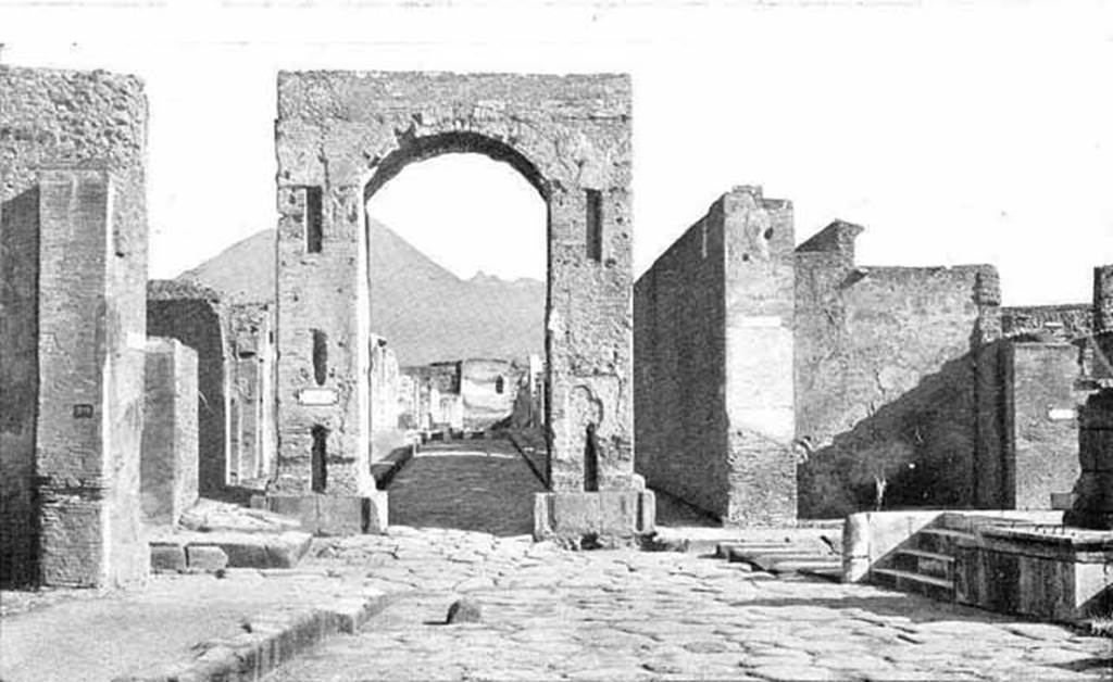 Arch of Caligula. About 1900. South side, looking north to Tower XI, the Tower of Mercurio.
Photo courtesy of Rick Bauer.
D�apres Thedenat, Les arcs de triomphe de Tib�re au Forum et de la rue de Mercure ont �t� utilis�s comme colonnes d'ascension pour les eaux. 
On voit m�me au pied de l'arc de Mercure l'arrachement des deux fontaines enlev�es probablement en m�me temps que les marbres du rev�tement.

According to Thedenat, the triumphal arches of Tiberius at the Forum and Via Mercurio were used as ascension columns for water.  
We can see also at the foot of the Arch of Mercury the site of the uprooting of the two fountains removed probably at the same time as the marbles of the cladding.
See Thedenat, H., 1906. Pompei: Vie Publique. Paris: Renouard. (Fig. 71, p. 128)