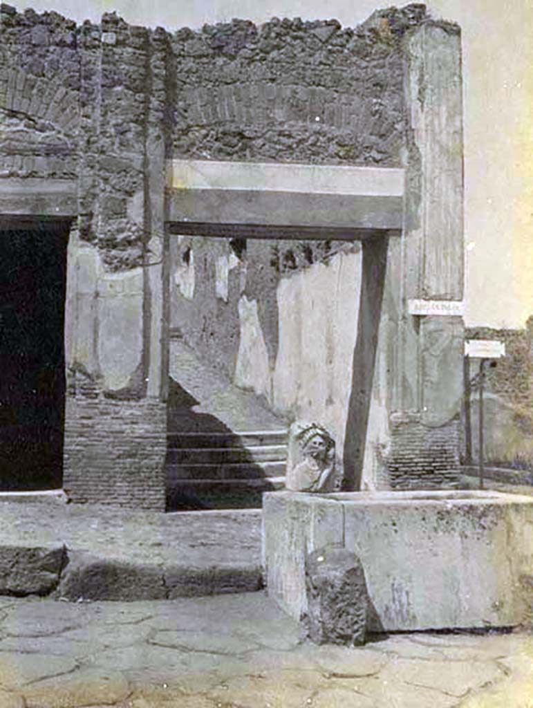 VII.9.67 Pompeii, 5th June 1925. 
Looking north on Via dell�Abbondanza towards fountain and rear steps at VII.9.67. Photo courtesy of Rick Bauer.

