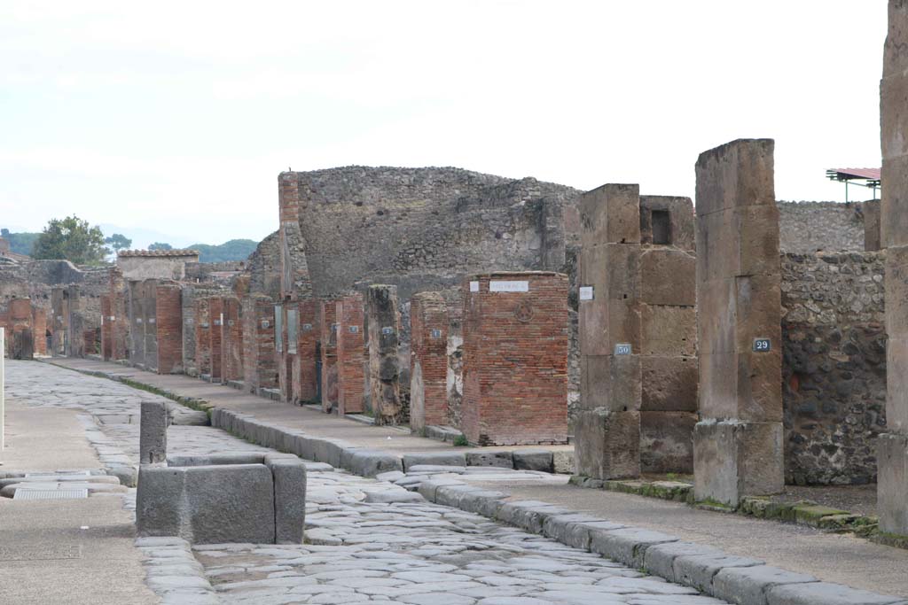 Fountain outside VII.14.13 and VII.14.14 on Via dell�Abbondanza, south side, Pompeii. December 2018. 
Looking east towards junction with Via dei Teatri, and Insula VIII.4, on left and VIII.5, on right. Photo courtesy of Aude Durand.

