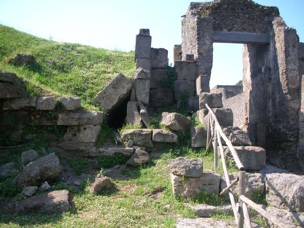 Porta di Nocera or Nuceria Gate, Pompeii. May 2010.
Looking north on west side of gate, towards site of outlet of drain, centre left. Photo courtesy of Ivo van der Graaff.