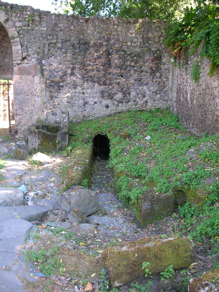 Porta Stabia, Pompeii. May 2010.
Looking south towards drain on north side of gate, with fountain, on left. Photo courtesy of Ivo van der Graaff.