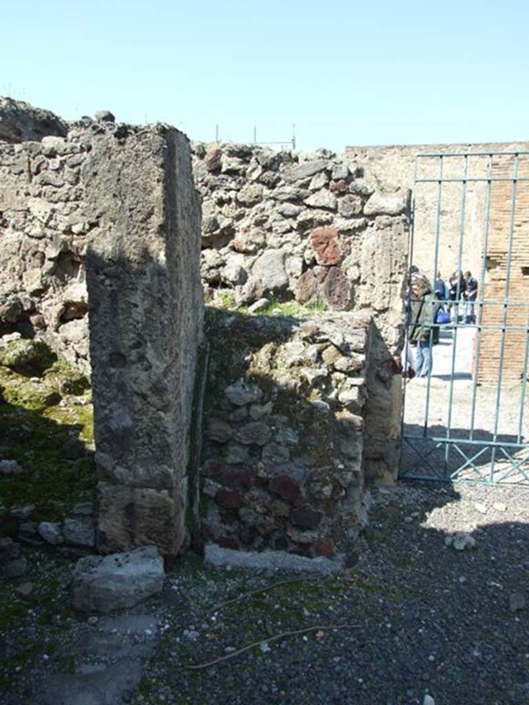 VIII.4.15 Pompeii. March 2009. Room 1, atrium. Remains of altar base in north-west corner of atrium. 
According to Boyce –
Upon a masonry base (1.15 by 0.85, h. 1.25), called una specie di altare con nicchia disopra, built into the north-west corner of the atrium, 
were painted several figures grouped about a tripod, among them the Genius with a patera and opposite him, the popa with an axe.
See Boyce G. K., 1937. Corpus of the Lararia of Pompeii. Rome: MAAR 14. (p.76, no. 362.
See Giacobello, F., 2008. Larari Pompeiani: Iconografia e culto dei Lari in ambito domestico. Milano: LED Edizioni, (p.200, no.91).

