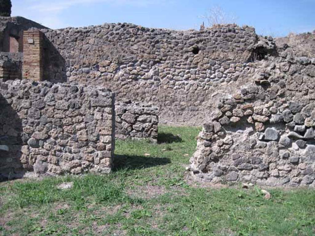 I.1.8 Pompeii. September 2010. North wall of entrance room, with doorway leading to I.1.9.
In the 2011 excavations led by Stephen Ellis they were able to recognise its precise location of the lararium.
It would have been on the wall to the right of the doorway in this photograph.
This conclusion was based on the sketches themselves more than on the earliest written descriptions.
The altar appears in the sketch to have been three-dimensional, with a tile jutting out from the wall face upon which to place offerings.
Their analysis of the standing architecture revealed what may be the remnants of that tile.
On the southern face of the north wall in the entrance area, a heavily damaged tile projecting from the wall is preserved. On the top of this tile are traces of plaster, and mortar can be seen on its under-side – this served to level the tile within the uneven wall construction.
If this was indeed the same tile as shown in the sketches, then we are able to place the shrine to the east of the southern door from I.1.8 to I.1.9, and thus on the northern wall of the entrance courtyard of I.1.8.
Here it would have been visible from the street.
See www.fastionline.org/docs/FOLDER-it-2012-262.pdf
Photo courtesy of Drew Baker.