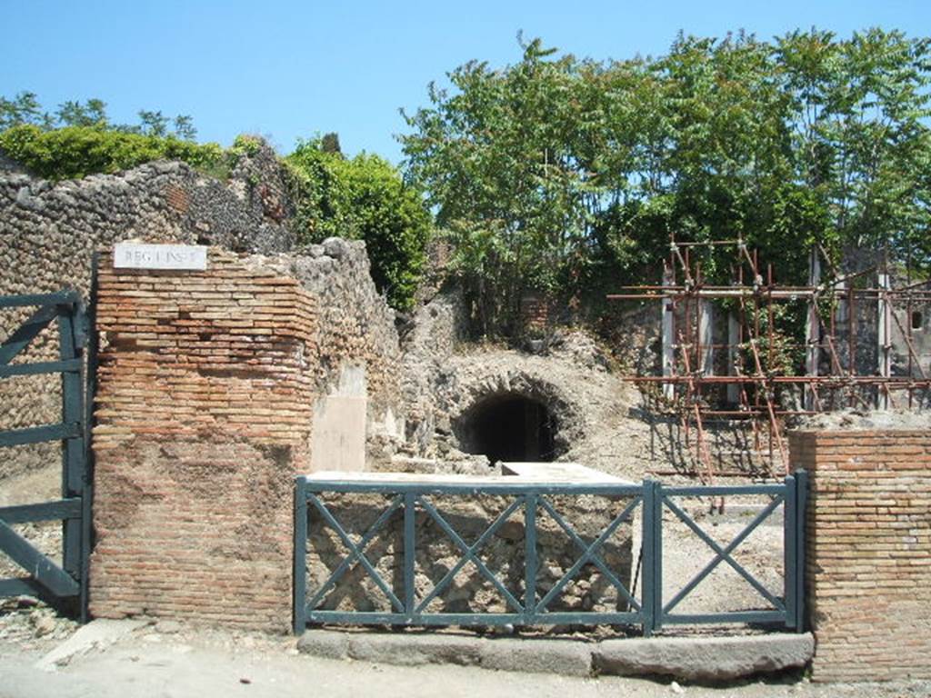 I.2.13 Pompeii. May 2005. Entrance doorway, looking east. On the right of the entrance doorway would have been the site of the south wall of the bar. This wall was destroyed in the 1943 bombing together with a niche or recess in the south wall. According to Boyce, on the wall was a lararium painting but only the lower parts of two figures (one a Lar) remained. Two serpents confronted at an altar with offerings.
See Boyce G. K., 1937. Corpus of the Lararia of Pompeii. Rome: MAAR 14. (p.22, no.7). According to Sogliano, the sacred picture was destroyed (by 1879). See Sogliano, A., 1879. Le pitture murali campane scoverte negli anni 1867-79. Napoli: (p.19, no.65)