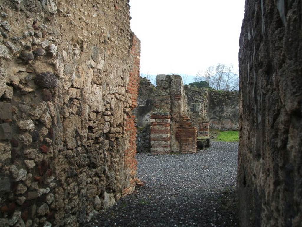 I.3.20 Pompeii. December 2007. Looking south along entrance corridor towards atrium and rear of peristyle.
According to Boyce, on the right side of the peristyle stood a small altar, coated with stucco.
On the yellow background, there were painted festoons and masks.
The excavation report called it a lararium.
He gives the reference Bull. Inst., 1869, 242.
This is no longer in situ.
See Boyce G. K., 1937. Corpus of the Lararia of Pompeii. Rome: MAAR 14. (p. 24)