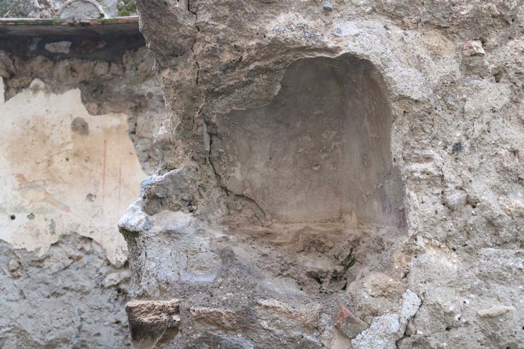 I.10.6 Pompeii. December 2018. Niche on west wall. Photo courtesy of Aude Durand.
According to Boyce, this arched niche (h.0.33, w.0.43, d.0.23, h. above floor 1.45) was painted red on the inside.
A thick ledge was indicated in the stucco below it, although the floor does not project.
See Notizie degli Scavi di Antichità, 1934, 276f.
See Boyce G. K., 1937. Corpus of the Lararia of Pompeii. Rome: MAAR 14. (p.29, no.55).