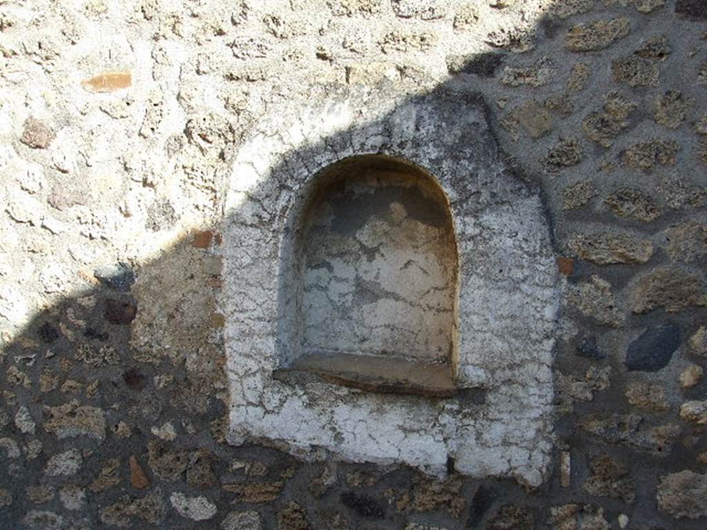 I.11.13 Pompeii. December 2006.
Arched niche lararium on east wall. The niche and surrounding wall panel were plastered and painted white.
See Giacobello, F., 2008. Larari Pompeiani: Iconografia e culto dei Lari in ambito domestico. Milano: LED Edizioni. (p.258, no.V16)
(She locates the lararium niche as being on the south wall).