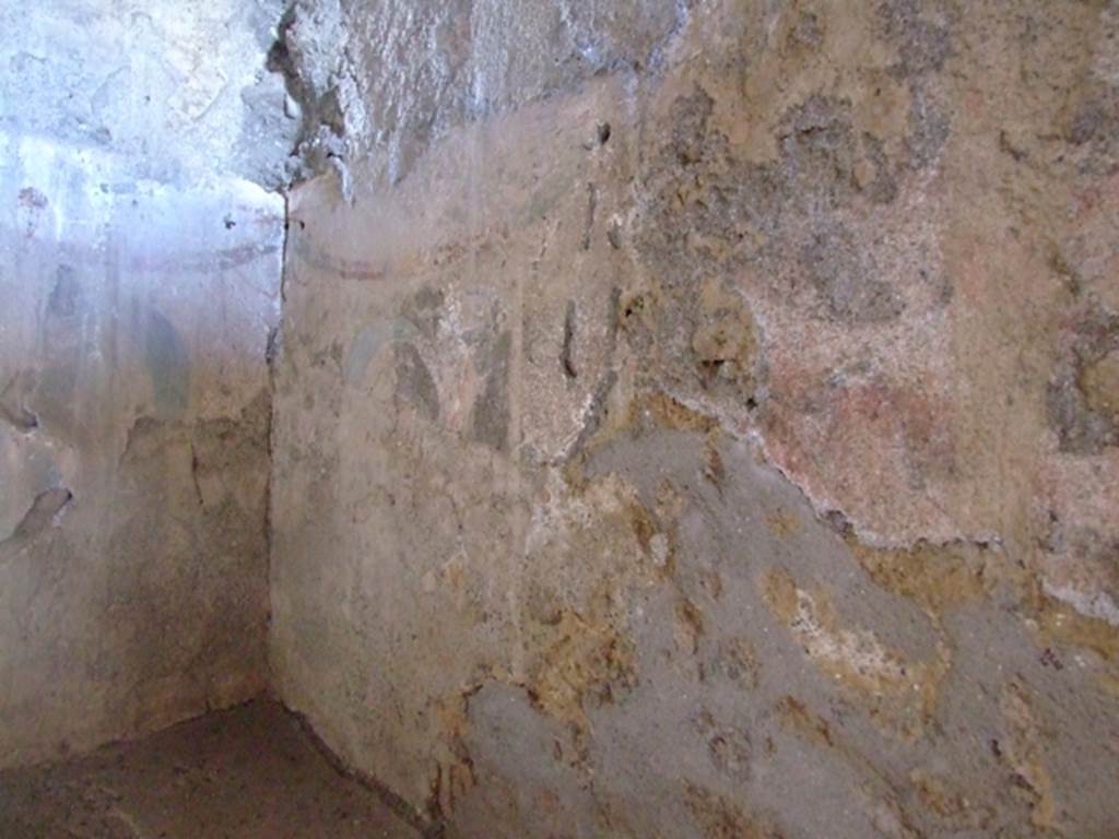 I.12.11 Pompeii. March 2009.
Lararium painting in south-east corner and south wall in kitchen above hearth with traces of painted garlands.