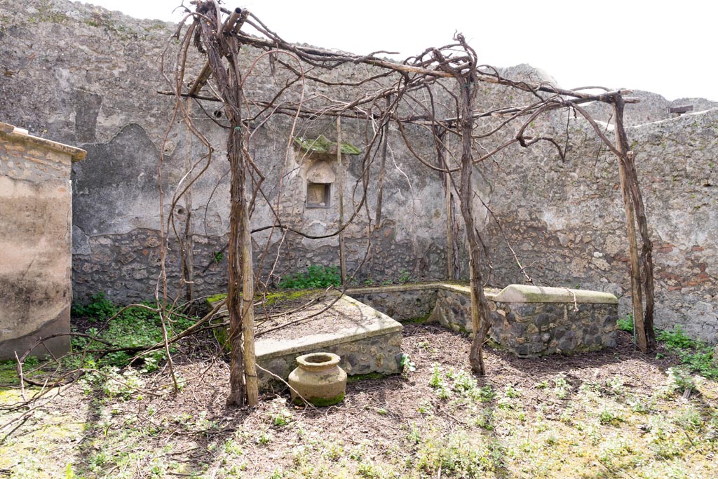 I.13.2 Pompeii. March 2023.
Looking south across summer triclinium towards south wall with lararium niche. Photo courtesy of Johannes Eber.