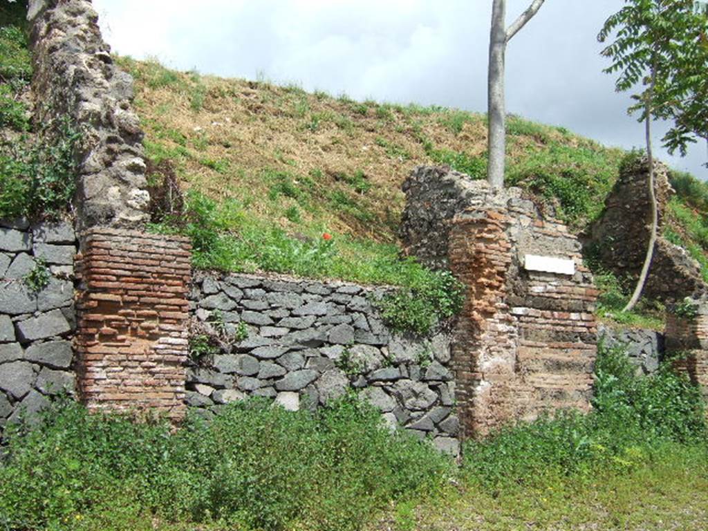 IV.2.e Pompeii. May 2006. Entrance. According to Liselotte Eschebach, there was a Lararium inside to the left. She suggested this was Boyce number 70. Boyce simply described a niche in the west wall for the domestic gods.
See Boyce G. K., 1937. Corpus of the Lararia of Pompeii. Rome: MAAR 14. (p.31, no. 70).
See Eschebach, L., 1993. Gebäudeverzeichnis und Stadtplan der antiken Stadt Pompeji. Köln: Böhlau. (p.118, IV.2.5).
According to Sogliano, the walls of the workshop were coated with rough plaster, and offered nothing of interest except the niche of the domestic gods in the west wall. Many items that were discovered in the workshop are listed in NdS, pages 279-80.
Some of these items showing signs of burning from the fire that must have developed here.
See Notizie degli Scavi di Antichità, 1905 (p.279-80).