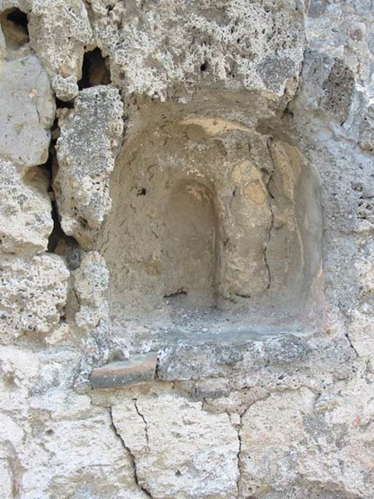 V.1.13 Pompeii. May 2003.
Niche in south wall, with small vaulted recess at rear for a statue. Photo courtesy of Nicolas Monteix.
According to Boyce –
In the south wall of the corridor that leads to rear rooms, is an arched niche (h.0.38, w.0.34, d.0.18, h. above floor 1.45);
in the rear wall of it there is a small vaulted recess, apparently for a statuette, and in the floor, a hole for the insertion of the base.
See Boyce G. K., 1937. Corpus of the Lararia of Pompeii. Rome: MAAR 14. (p.32, no.73)
According to Boyce – 2 bronze statuettes were found in the room, one of a Lar (height 0.115), one of Mercury with winged petasos (height 0.112).
He quoted references - Giorn. Scavi, N.S, iii, 1877, p.253, Bull. Inst, 1877 p.136, and VIOLA, Scavi, pp74, No.8, 75, No.18.
See Boyce G. K., 1937. Corpus of the Lararia of Pompeii. Rome: MAAR 14. (p.32, no.73).