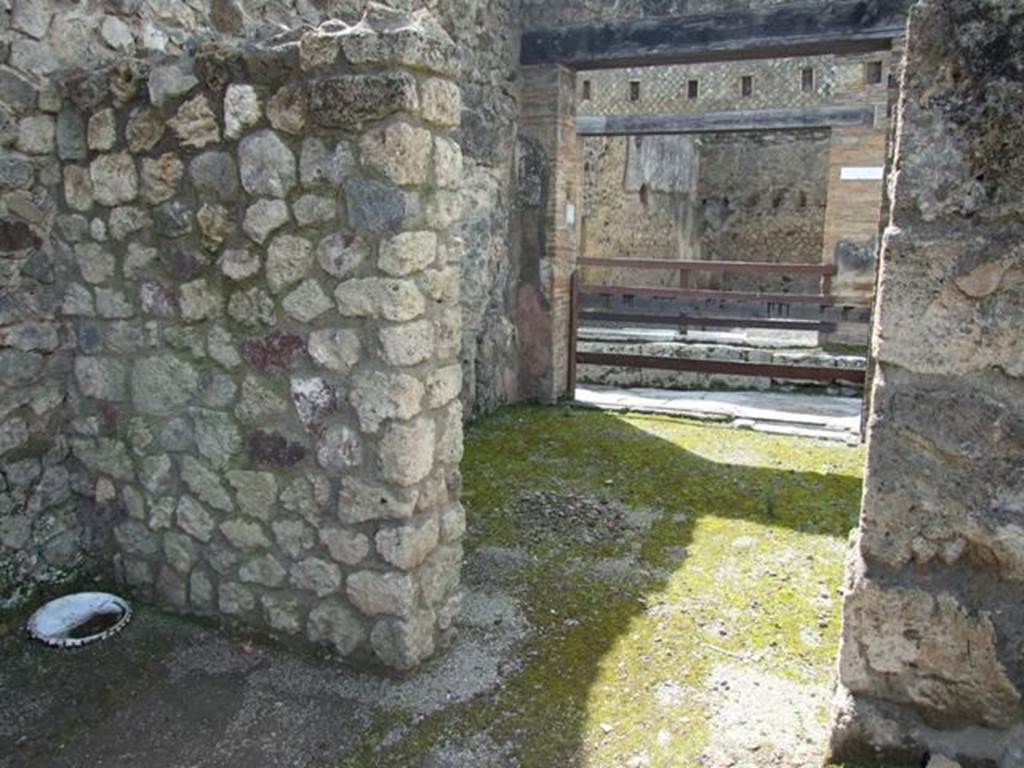 V.1.15 Pompeii. April 2009. Doorway to room on south side of entrance, leading into V.1.16. Looking west.
According to Boyce, in this area should have been the lararium, presumably destroyed in 1943.
He described it as being in a house transformed into a workshop.
In the west wall of the atrium, near the south-west corner was a rectangular niche (h.0.53, w.0.63, d.0.22, h. above floor 1.25) with aedicula façade and projecting floor.
The inside walls were painted blue and the opening of the niche was outlined with red stripes on the white background of the wall of the room.
See Boyce G. K., 1937. Corpus of the Lararia of Pompeii. Rome: MAAR 14. (p.32, no.74)
)
