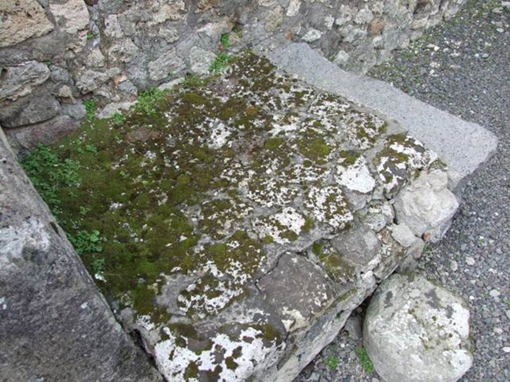 V.2.13 Pompeii. March 2009. South-west corner of thermopolium, and masonry hearth or base.
According to Boyce,
“Above the hearth in the south-west corner is a poorly preserved lararium painting: The Genius is represented sacrificing at an altar; on each side originally stood a Lar, only the one on the right being now preserved; further to the right a single serpent approaches an altar.
The above description is taken from Sogliano published in 1879; the descriptions of this house in Rom. Mitt and Not. Scavi, published fifteen and seventeen years later, mention only an altar is visible in a painting, but presumably all refer to the same shrine.”
See Boyce G. K., 1937. Corpus of the Lararia of Pompeii. Rome: MAAR 14, (p.34, no.92).
According to NdS, this thermopolium had a sales counter and a small hearth.
On the west wall Sogliano could see the remains of a painted lararium, with a serpent sliding towards an altar on the left.
At the rear was located the room for the customers, which was bordered by a corridor to the latrine.
See Notizie degli Scavi di Antichità, 1896, (p.438)