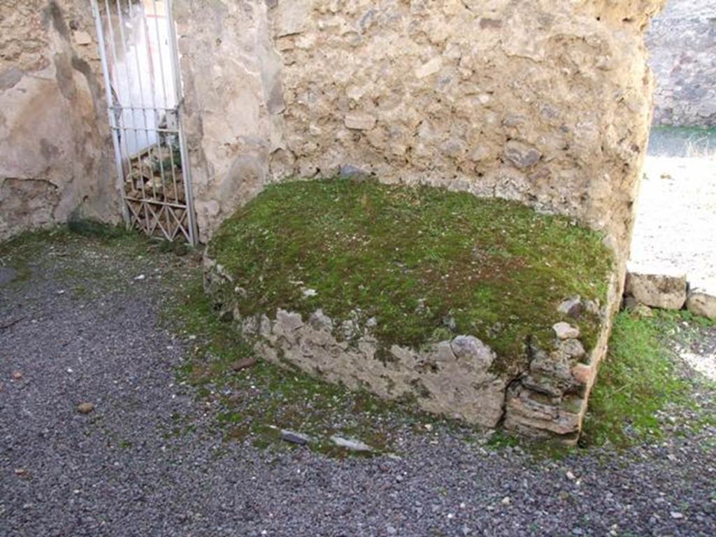 V.2.i Pompeii. December 2007. Room 11, looking towards west wall in kitchen.
According to Mau above this bench or hearth were the remains of a painting of the 2 Lares.
Near them a serpent was seen coiled around an altar, on which was a large pine cone.
See Mau, A., 1907, translated by Kelsey F. W. Pompeii: Its Life and Art. New York: Macmillan. (p.307).
Boyce also mentioned that a man was leading a reluctant hog.
He also said the lower zone was not well preserved and only a few traces of the foliage remained, through which the usual serpents must have glided.
See Boyce G. K., 1937. Corpus of the Lararia of Pompeii. Rome: MAAR 14. (p.38, no.109).