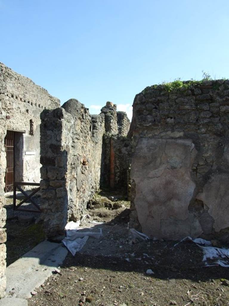 V.3.10 Pompeii. March 2009. Doorway to Kitchen and Latrine, on south side of atrium.