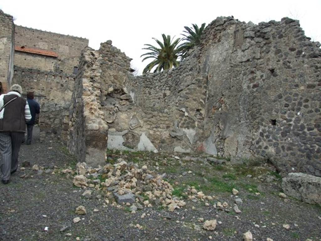 V.4.1 Pompeii. December 2007. Looking north across site of small garden on east side of atrium. Nothing much remains.
According to Jashemski, this small garden area had a masonry planting bed at the base of the north, east and south walls. The cistern puteal was near the south-west corner. Against the east wall was a podium.
See Jashemski, W. F., 1993. The Gardens of Pompeii, Volume II: Appendices. New York: Caratzas. (p.116)
According to Boyce, the podium was an altar. In the wall above it was a shallow niche. The inside walls of the niche were originally covered with slabs of white marble.
See Boyce G. K., 1937. Corpus of the Lararia of Pompeii. Rome: MAAR 14. (p.39, no.117)