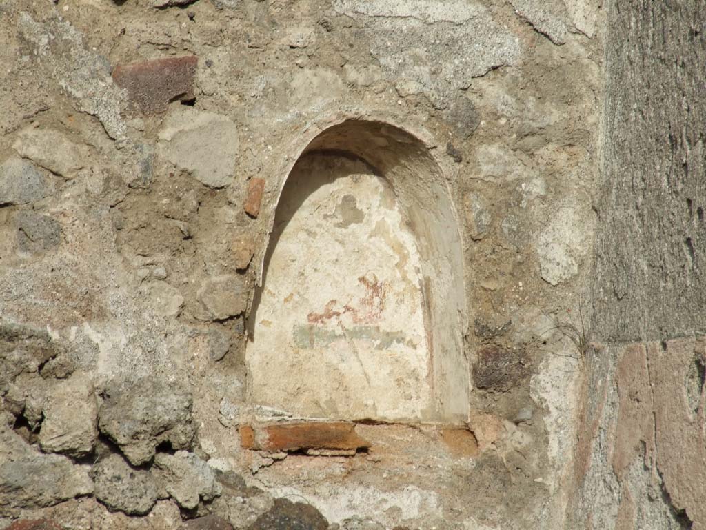 VI.1.1 Pompeii. December 2007. Niche with vaulted ceiling, on north wall.
Originally this was at the east end of the north wall of a windowless sacrarium.
The walls of the niche were coated with white stucco with floral ornaments.
The rear wall was outlined with red stripes and had a painting of a wreathed figure.
On the floor in front, but near the north wall, stood a masonry altar decorated with the figure of a pig which wore a garland on its head.
See Fiorelli G., 1860. Pompeianarum antiquitatum historia, Vol. 1: 1748 - 1818, Naples, ii, 36 (March 8 1787).
See Boyce G. K., 1937. Corpus of the Lararia of Pompeii. Rome: MAAR 14. (p.43, no.132, Pl.40, 3 & 4).
See Mazois, F., 1824. Les Ruines de Pompei : Second Partie. Paris: Firmin Didot. (p. 47 and pl. 10, 1 & 2).