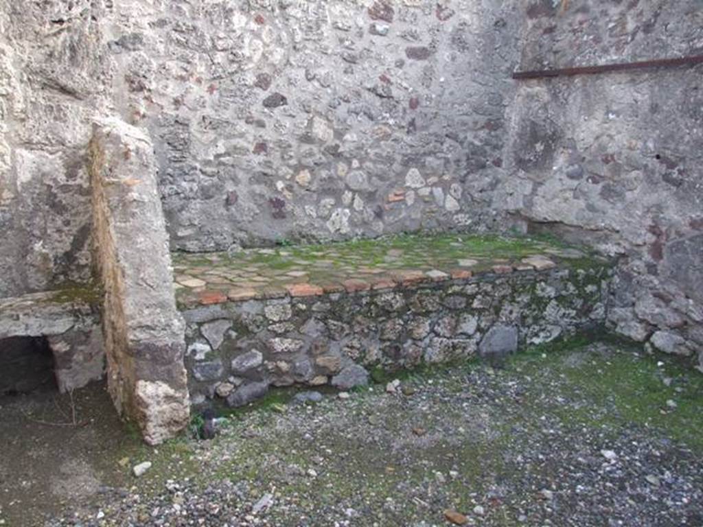 VI.1.10 Pompeii. December 2007. Room 11, east wall with latrine and hearth,and south-east corner of kitchen. According to Boyce, the print in Piranesi showed the south wall of the kitchen covered with a lararium painting in two zones. In the upper zone was the figure of the Genius, pouring a libation on an altar, to the right of him stood a small Camillus.
On each side of this central group was an indistinct figure. Above this zone are two other indistinct figures. In the lower zone were the two serpents confronted at an altar. See Boyce G. K., 1937. Corpus of the Lararia of Pompeii. Rome: MAAR 14. (p.43, no.135)
According to Giacobello, in the south corner of the kitchen a lararium painting was found upon excavation, but in a bad condition. It is no longer conserved, but drawn by Piranesi. Nissen referred to the existence of a niche near the hearth, no longer visible by Boyce’s time.
See Giacobello, F., 2008. Larari Pompeiani: Iconografia e culto dei Lari in ambito domestico. Milano: LED Edizioni. (p.171)
See Fröhlich, T., 1991. Lararien und Fassadenbilder in den Vesuvstädten. Mainz: von Zabern. (L56, picture 37,2)
According to Boyce, Nissen referred to a niche for the Lares in one of the rooms in the neighbourhood of the kitchen. Nissen, 410
See Boyce G. K., 1937. Corpus of the Lararia of Pompeii. Rome: MAAR 14. (p.43, no.136)