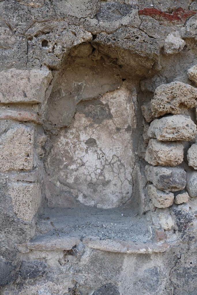 VI.1.14 Pompeii. December 2018. Arched niche in north wall. Photo courtesy of Aude Durand.
According to Boyce –
the walls of the niche (h.0.60, w.0.40, d.0.25, height above the floor 1.10) were coated with red stucco.
See Boyce G. K., 1937. Corpus of the Lararia of Pompeii. Rome: MAAR 14. (p.42, no.137).
