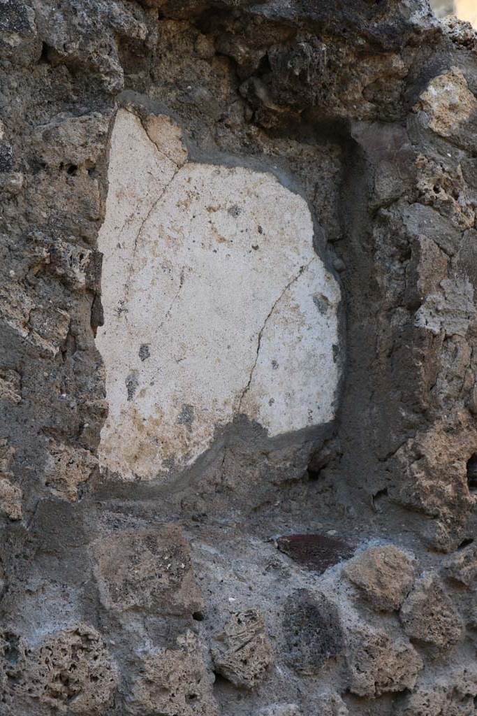 VI.2.1 Pompeii. December 2018.
Detail of niche in north wall of bar-room. Photo courtesy of Aude Durand.
According to Boyce-
the large rectangular niche (h.0.65, w.0.50, d.0.18, height above the floor 1.45) had its inside walls painted green.
Fiorelli referred to it as “la nicchia dei Penati”
See Boyce G. K., 1937. Corpus of the Lararia of Pompeii. Rome: MAAR 14. (p44, No.138)