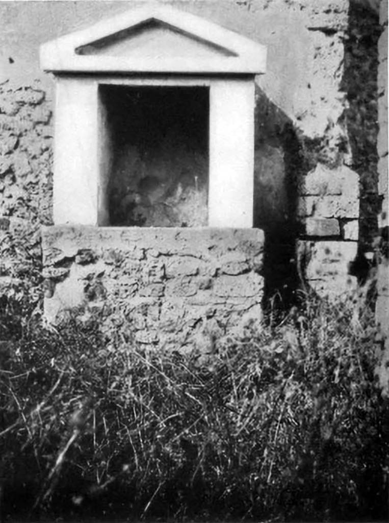 VI.5.14 Pompeii. 1930s photo of lararium by Tatiana Warscher.
According to Boyce, it had a solid base with two heavy walls forming a rectangular niche, surmounted by a gable roof with a simple pediment.
The walls inside were covered with unpainted white stucco.
In the floor was embedded a square block of marble, in which was cut a rectangular hole.
It was as if this was meant to hold the pivot upon which turned a door to close the shrine.
See Boyce G. K., 1937. Corpus of the Lararia of Pompeii. Rome: MAAR 14. (p.46, no.154, and Pl.34,2)
See Giacobello, F., 2008. Larari Pompeiani: Iconografia e culto dei Lari in ambito domestico. Milano: LED Edizioni. (p.269)