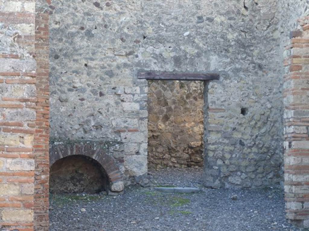VI.7.15 Pompeii. December 2007. Hearth in kitchen area against west wall. According to Boyce, on the west wall of the kitchen there was a lararium painting on a white background. A serpent glides through plants towards an altar furnished with an egg and pine cone. Below the painted altar, a piece of tile projected from the wall, to serve for lamp or offerings. To the right of the same altar, stood the Genius, crowned, wearing high boots and a toga with a fold drawn over his head.
See Boyce G. K., 1937. Corpus of the Lararia of Pompeii. Rome: MAAR 14. (p.48, no.165) He also gave Helbig as a reference: See Helbig, W., 1868. Wandgemälde der vom Vesuv verschütteten Städte Campaniens. Leipzig: Breitkopf und Härtel. (32)