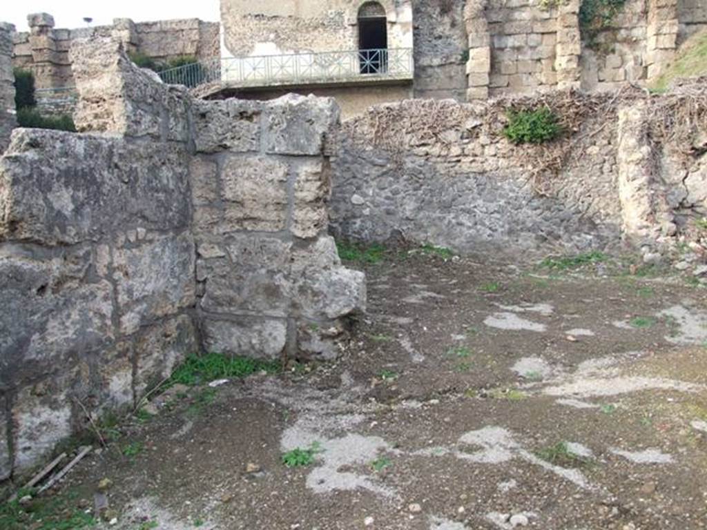 VI.9.1 Pompeii. December 2007. Looking across site of room 14 towards the kitchen, room 13 in north-west corner. Looking north from near entrance.
According to Fiorelli, this area would have been the site of a storeroom and kitchen and latrine.
According to Warscher, the room “b” (our room 14) had a low level and in front of the door into the kitchen, there was a tufa step.
See Warscher, T, 1938: Codex Topographicus Pompejanus, Regio VI, insula 9: Pars prima, Rome, DAIR.
