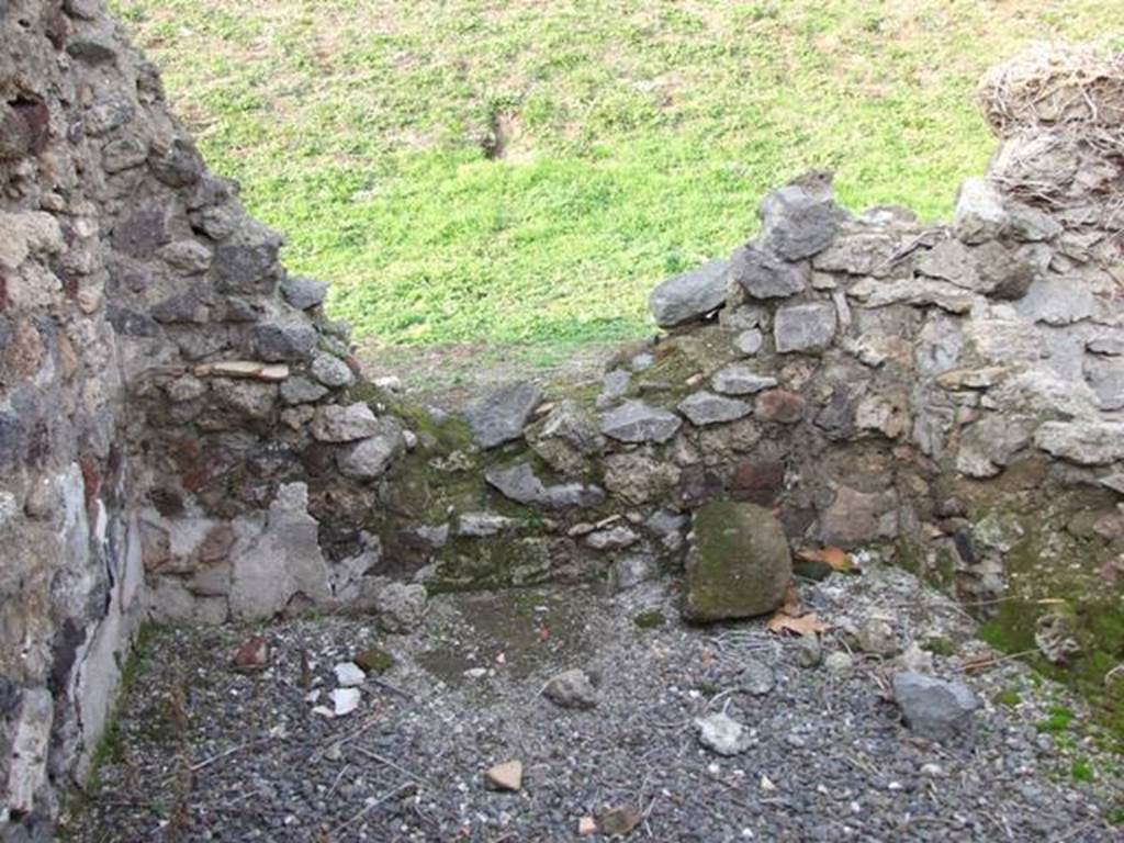VI.9.14 Pompeii. December 2007. Room 28, north wall of kitchen. In this area was found a badly preserved hearth, and there was formerly a lararium in the room. According to Boyce, Avellino reported a lararium painting in the kitchen – il solito dipinto de’ Lari. He quoted the reference Bull. Arch. Nap., i, 1843, 70
See Boyce G. K., 1937. Corpus of the Lararia of Pompeii. Rome: MAAR 14. (p.49, no.173)