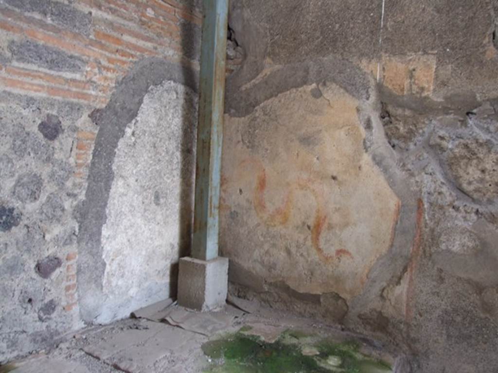 VI.9.7 Pompeii. March 2009. Room 4, painted lararium in north-west corner of kitchen.
According to Boyce, in the north-west corner above the hearth is a painting of two red and yellow serpents. The one on the right has red crest and beard; the head of the other is destroyed. They approach an altar. There are garlands above.
See Boyce G. K., 1937. Corpus of the Lararia of Pompeii. Rome: MAAR 14. (p.50, 178)