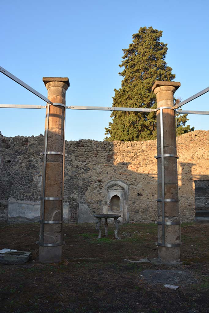 VI.13.13 Pompeii. October 2019.
Looking west across peristyle towards aedicula lararium against west wall of garden area.
Foto Annette Haug, ERC Grant 681269 DÉCOR.
According to Boyce, against the west wall of the peristyle stands a simple aedicula (0.75 by 0.30, height 2.15).
Above a base (0.80) two side walls support a roof with small pediment, protecting a vaulted niche (h.0.76, w.0.43, d.0.40).
The whole structure is coated with a layer of white stucco.
See Boyce G. K., 1937. Corpus of the Lararia of Pompeii. Rome: MAAR 14. (p.52, no.195, and Pl.35,4).
He quoted Not. Scavi 1876, 78, Bull. Inst. 1877, p. 164, 168)
See Giacobello, F., 2008. Larari Pompeiani: Iconografia e culto dei Lari in ambito domestico. Milano: LED Edizioni, (p.274 no.V51)