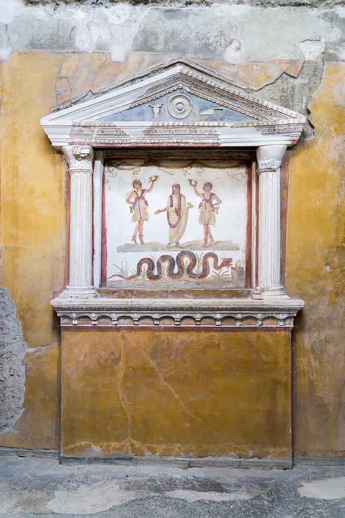 VI.15.1 Pompeii. March 2023.
Household lararium on west wall in service area. Photo courtesy of Johannes Eber.