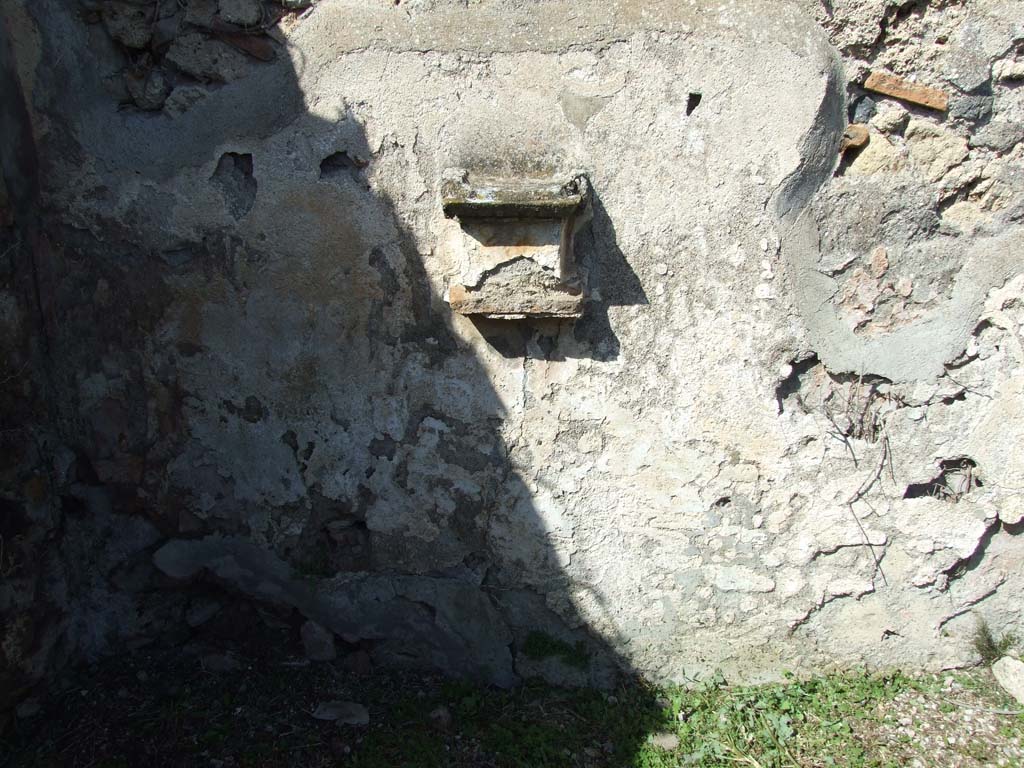 VI.16.12 Pompeii. March 2009. North wall with masonry altar projecting from wall.
There used to be two painted serpents, one either side of the altar.
A painted pine cone was on the wall above the altar.
See Warscher, T., 1925. Pompeji: Ein Führer durch die Ruinen. Berlin und Leipzig: de Gruyter. (p.102, abb 21).