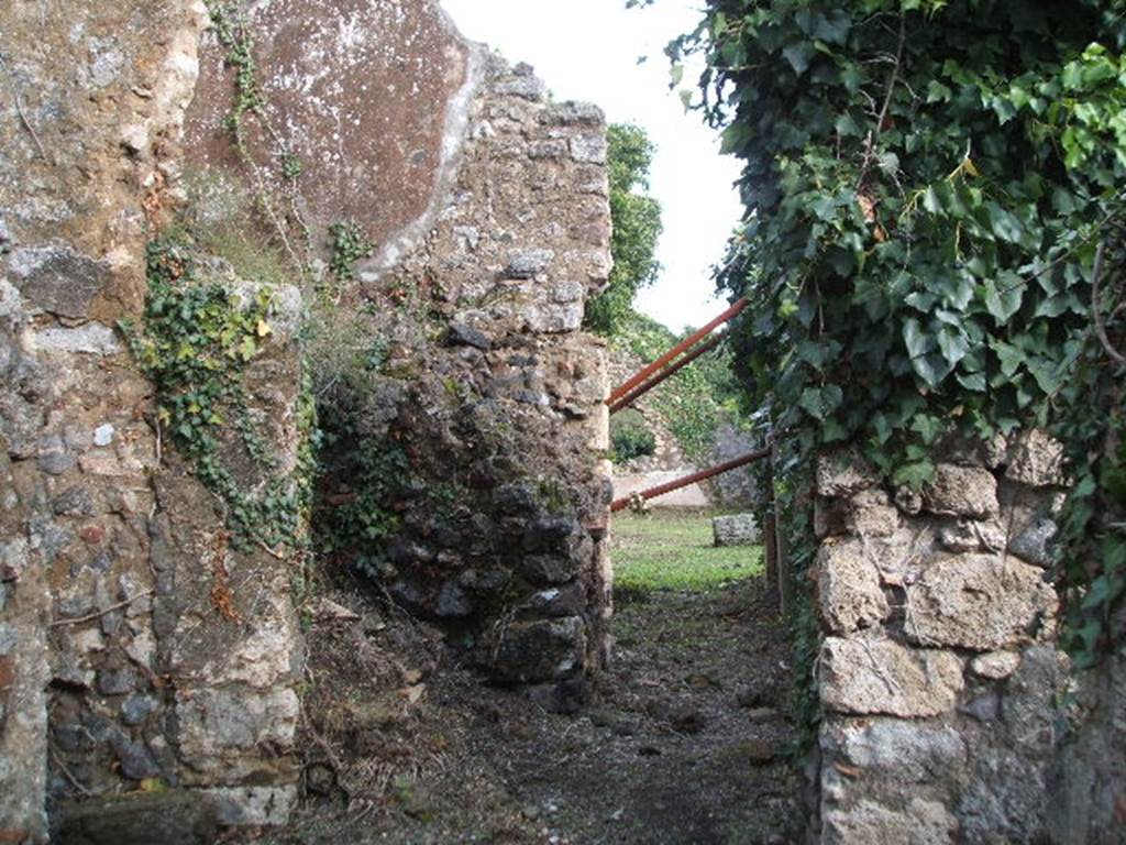 VI.16.31 Pompeii. December 2004. Looking east from entrance doorway. The doorway led immediately into a short and wide fauces A, with earth floor and rustic walls. In the centre left of this photo can be seen the remains of the ramps of masonry stairs that led above. On the left of this photo was a doorway into a large room B, which was as rustic as the corridor.
In the top of the west wall was a window, and there was a niche in the south wall. In the south-west corner was a low masonry structure. According to Eschebach room B was the kitchen.
See Eschebach, L., 1993. Gebäudeverzeichnis und Stadtplan der antiken Stadt Pompeji. Köln: Böhlau. (p.231)
According to Boyce, in the kitchen (?) on the left side of the fauces, in the south wall above the hearth (?) was a rectangular niche (h.0.30, w.0.22, d.0.22, height above the floor 1.50). See Boyce G. K., 1937. Corpus of the Lararia of Pompeii. Rome: MAAR 14. (p.59, no.228)
According to Giacobello, in the kitchen (room E) was a niche on the south wall, near the hearth. Today there is no trace. See Giacobello, F., 2008. Larari Pompeiani: Iconografia e culto dei Lari in ambito domestico. Milano: LED Edizioni. (p.186)