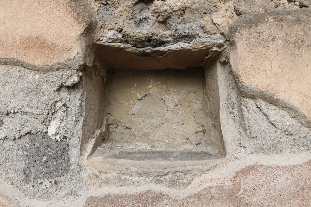 VII.1.11 Pompeii, December 2018. Niche/recess in north wall. Photo courtesy of Aude Durand.
According to Boyce –
In the north wall is a square niche (0.28 square, d.0.24, h. above the floor 1.20), the walls of the niche were coated with the same white stucco which covered the walls of the room.
See Boyce G. K., 1937. Corpus of the Lararia of Pompeii. Rome: MAAR 14. (p.60, no.233).