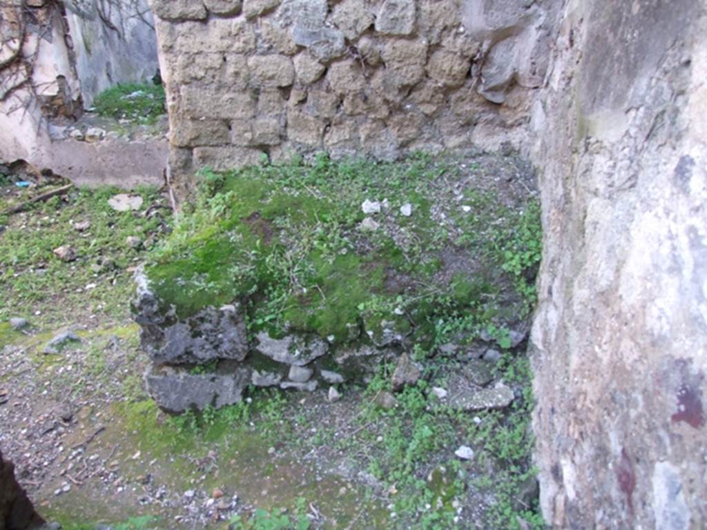 VII.2.14 Pompeii. March 2009. Masonry bench or hearth against south wall of kitchen. According to Boyce, in the west wall of the kitchen is an arched niche called in the report “una nicchia per I lari”. See Boyce G. K., 1937. Corpus of the Lararia of Pompeii. Rome: MAAR 14. (250, p. 62)