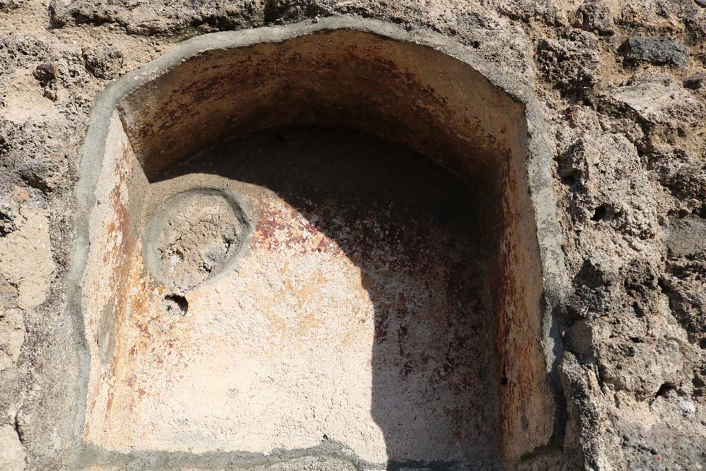 VII.3.10 Pompeii. December 2018. Niche in east wall. Photo courtesy of Aude Durand.
According to Boyce, the inside walls of this arched niche (h.0.55, w.0.45, d.0.27, h. above floor 1.50) were coated in red stucco.
Fiorelli called it la nicchia dei Penati.
See Boyce G. K., 1937. Corpus of the Lararia of Pompeii. Rome: MAAR 14. (p. 64, no.262)
See Pappalardo, U., 2001. La Descrizione di Pompei per Giuseppe Fiorelli (1875). Napoli: Massa Editore. (p. 86)