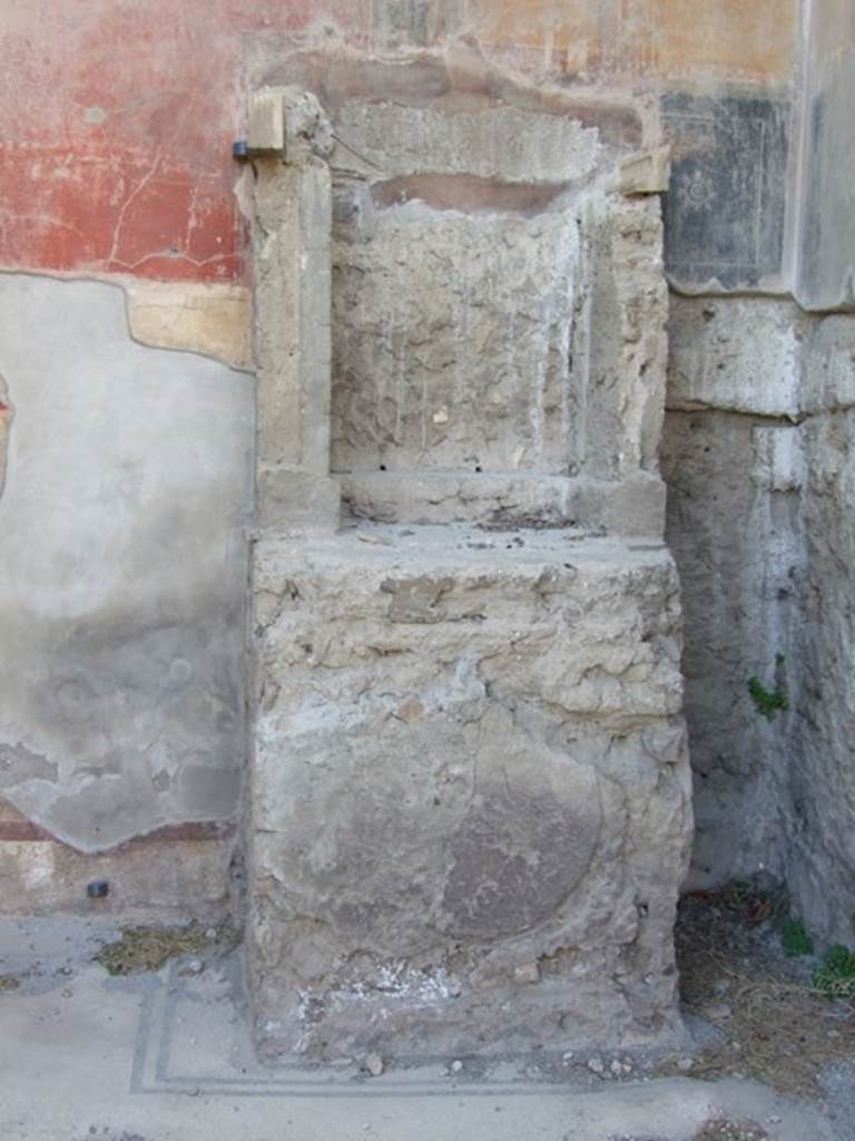 VII.4.31/51 Pompeii. March 2009. Room 6, lararium against west wall.
On the front of the base there is an impression of a round plaque in the plaster.
This must have once decorated it.
According to Boyce – in the left ala of the atrium stands an aedicula lararium.
Above a high podium (1.10 by 0.93, h.1.22), walls enclose a rectangular niche (h.0.96, w.0.80, d.0.50), the sides of which are reported to have been originally covered with marble.
See Boyce G. K., 1937. Corpus of the Lararia of Pompeii. Rome: MAAR 14. (p.66, no. 277)
See Giacobello, F., 2008. Larari Pompeiani: Iconografia e culto dei Lari in ambito domestico. Milano: LED Edizioni, (p.244, no.A26)