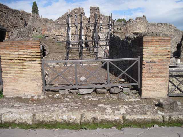 I.2.12 Pompeii. September 2010. Looking east from entrance. The lower remains of the north and east wall can be seen. In the north wall, on the left, was a doorway into the communicating bar-room. At the rear, in the east wall, was a doorway into the area with a wooden staircase to the upper floor and a passage leading to the latrine. Photo courtesy of Drew Baker.

