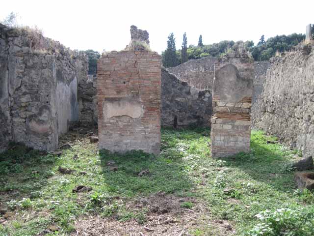 I.2.15 Pompeii. September 2010. Looking south-west from end of corridor on top of collapse. Photo courtesy of Drew Baker.
According to Garcia y Garcia, all the west part of the dwelling was completely destroyed in 1943. The bomb demolished the upper floor, leaving the cistern below uncovered and visible. See Garcia y Garcia, L., 2006. Danni di guerra a Pompei. Rome: L’Erma di Bretschneider.  (p.37)
