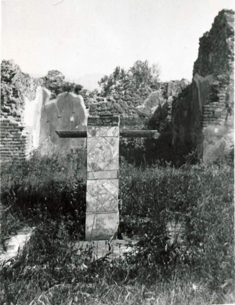 I.2.17 Pompeii. 1935 photograph taken by Tatiana Warscher.
Looking south across atrium towards base and impluvium.
According to Warscher, quoting Bull. Inst, 1874, p.264 –
I.2.17 “Nell’ atrio dietro l’impluvio di marmo sta un base, nella parte anteriore rivestita di marmo, e dietro di essa una tavola sopra sostegno quadrangolare.
La decorazione dell’atrio è semplice: sopra zoccolo nero scompartimenti neri, rossi e gialli.
A destra dell’entrata abbiamo una camera rozzamente decorata con finestra sul vico.
A sinistra primo un vano, che, come pare, conteneva la scala di legno, sotto la quale un armadio era accessibile dalle fauces, poi la cucina col cesso.
Sul lato destro dell’atrio non v’è nulla, su quel sinistro due camere, congiunte fra loro, la seconda con larga apertura sul peristilio.
Sul lato di fonde vi è il tablino, decorato nello stile della suddescritta stanza del ratto del Palladio (vedi p.199s.) colla pittura d’Endimione, descritta Bull. 1873, p.238.
Dietro il tablino, ma più a sinistra ed accessibile per una porta in fondo ad esso, troviamo un piccolo viridarium, le cui pareti nella parte più bassa hanno dipinto un cancello, sopra delle piante.
Appoggiata al muro destro vi è una vasca murata, alta m.0,58 dentro e 0,73 fuori, e un’altra accanto a questa prima verso S.
See Warscher T., 1935. Codex Topographicus Pompeianus: Regio I.2. (no.29), Rome: DAIR, whose copyright it remains.
(translation:
I. 2.17 "In the atrium behind the marble impluvium was a base, in the front part covered in marble, and behind it a table above a four-sided support. The decoration of the atrium was simple: above a black zoccolo were compartments of blacks, reds and yellows.
To the right of the entrance there is a rough room decorated with a window onto the roadway. To the left, first one room, which, as it seemed, contained the wooden staircase, under which a cupboard was accessible from the fauces, then the kitchen with toilet. On the right side of the Atrium there was nothing, on the left side two rooms, joined between them, the second with wide opening onto the peristyle. At the rear side there was the tablinum, decorated in the style of the described room of the painting of the Palladium (see I.2.6), with a painting of Endymion, described Bull. 1873, p. 238.
Behind the tablinum, but more to the left and accessible by a door at the back of it, we find a small viridarium, whose walls at the lowest part had paintings of a gate, with plants above. Leaning against the right wall there was a walled basin, alta m. 0.58 inside and 0.73 outside, and another next to this first towards the south.")